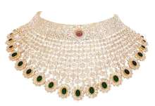 18k gold Bridal choker studded with uncut diamonds along with emeralds and a ruby at the centre by Tanya Rastogi for Lala Jugal Kishore Jewellers